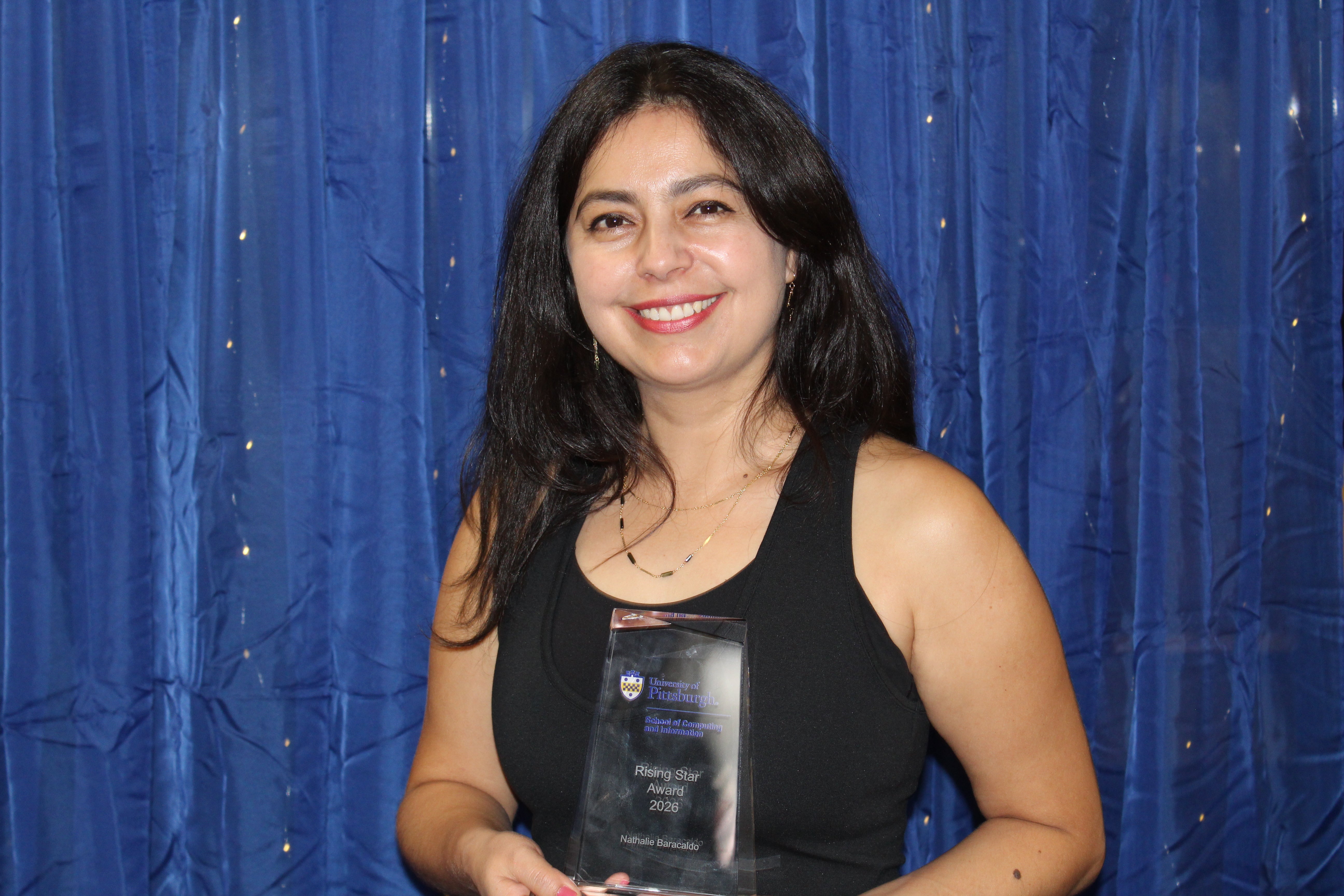 Natahlie Baracaldo holding her Rising Star Award