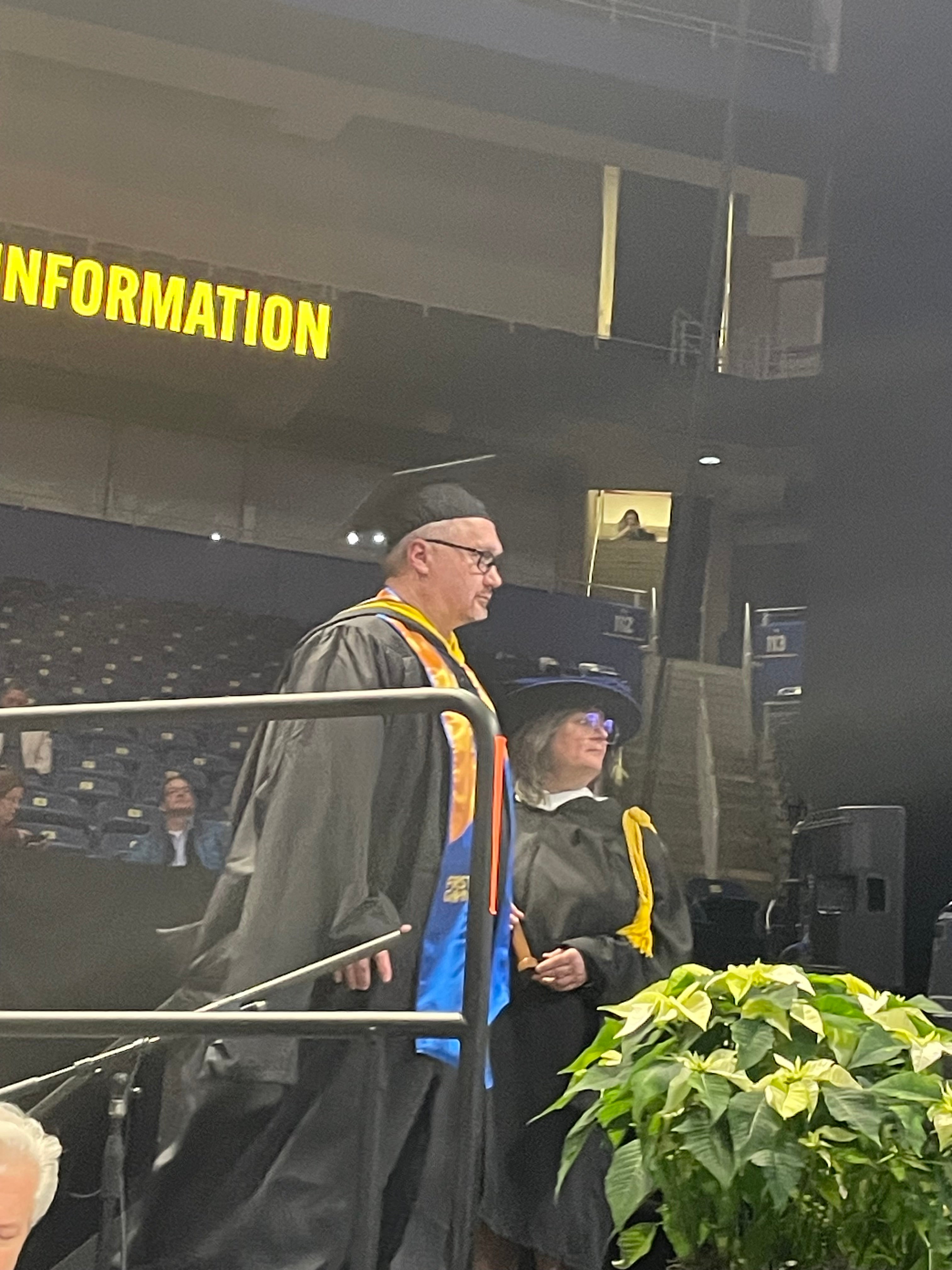 graduate walking across the stage to get their diploma