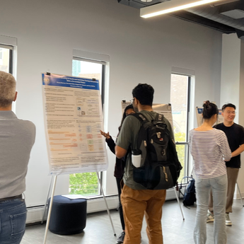 student presenting research poster