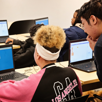 teacher looking over student's shoulder