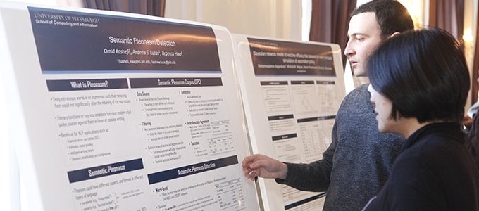 student presenting research poster