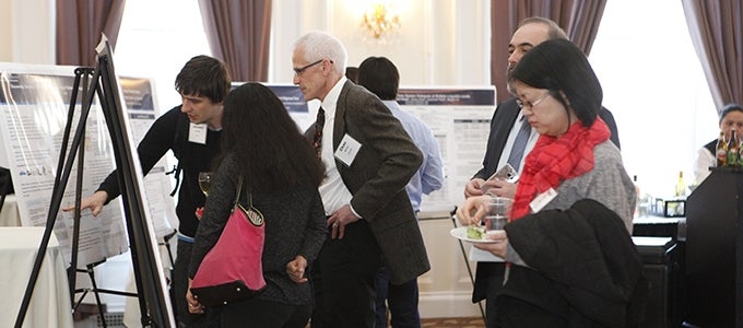 people standing at poster session