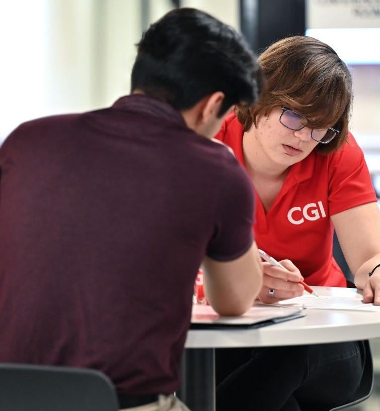 two people looking at a paper