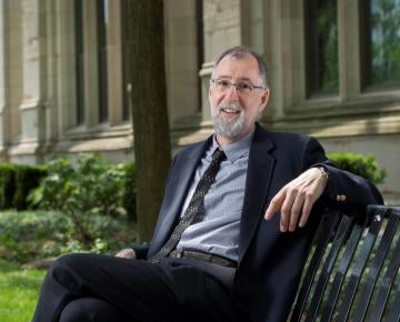 Photo of Paul Cohen sitting on a bench