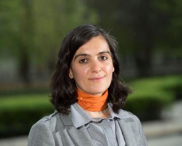 Photo of Rosta Farzan wearing an orange scarf