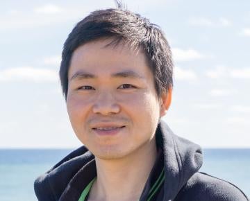 Photo of Stephen Lee in front of a body of water