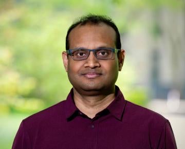 man wearing glasses and red shirt outside