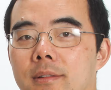 man wearing glasses in front of a white background