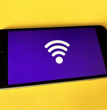 Photo of a cellphone with a wifi logo.