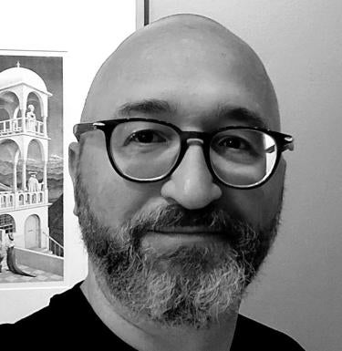 black and white photo of man with beard wearing glasses