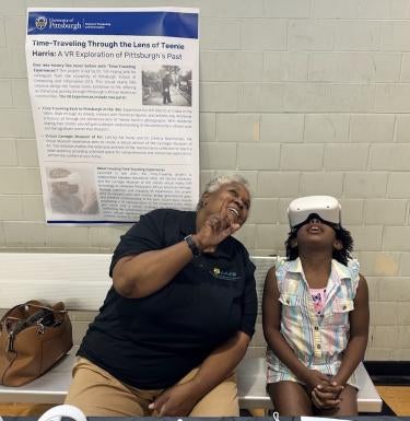 Photo of grandparent and child looking up. The child is wearing a VR headset.