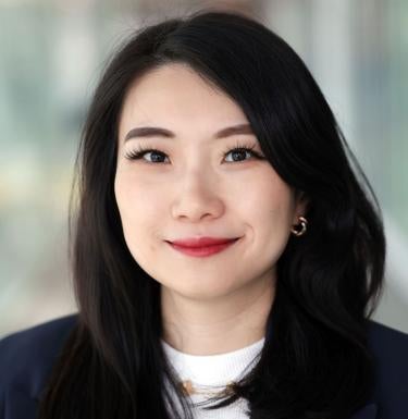 woman with long black hair wearing black blazer and a white shirt