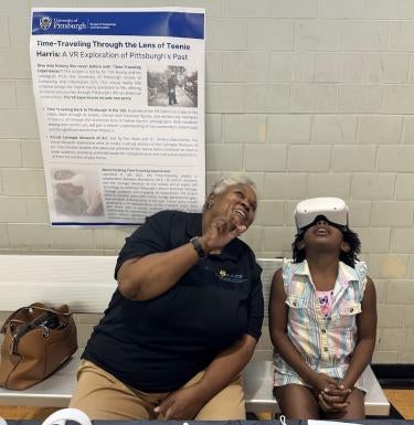 Woman and child wearing a VR headset look up on a bench inside a building