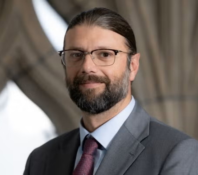 man wearing glasses and suit and tie