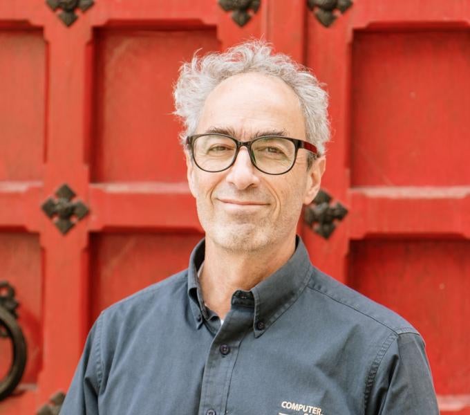 Photo of Daniel Mosse in front of a red door