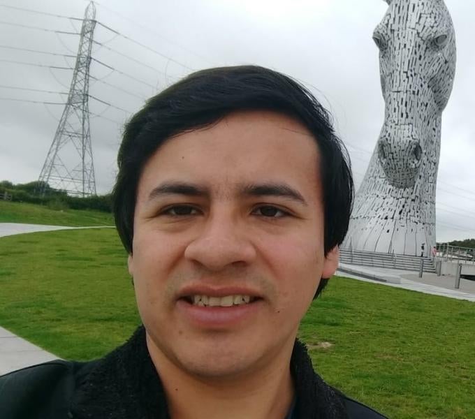 Photo of Nils Murrugarra-Llerena outside with a horse statue in the background