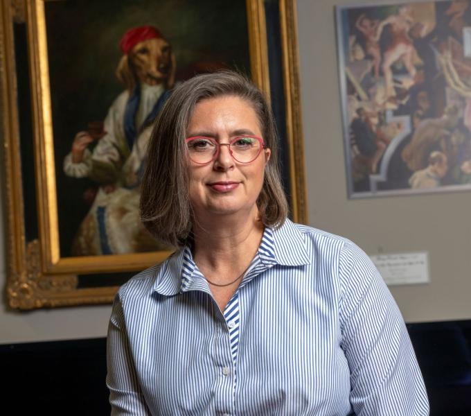 woman standing in front of paintings